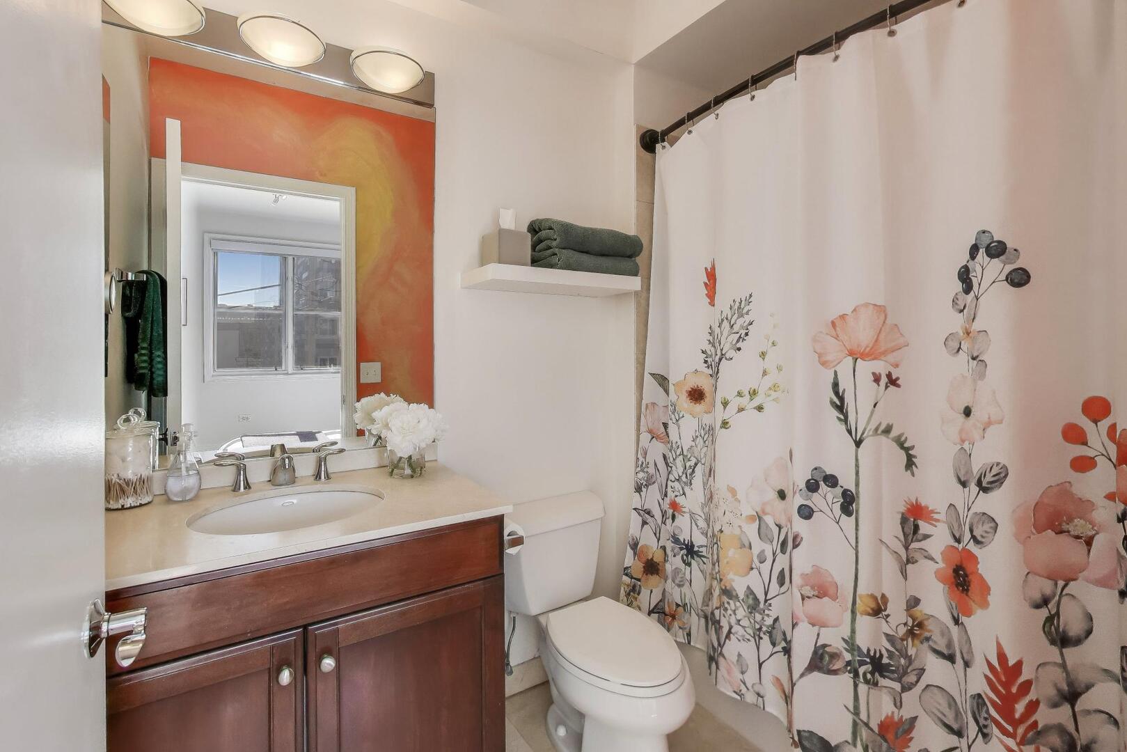 1137 West Monroe Street, Unit 9 Chicago, IL 60607 - Photo 16 of 31 a bathroom with a granite countertop sink a toilet and shower curtain