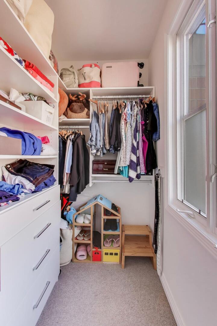 1137 West Monroe Street, Unit 9 Chicago, IL 60607 - Photo 21 of 31 a view of walk in closet with clothes and shoes