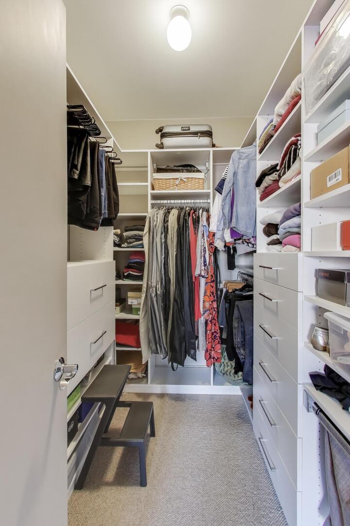 1137 West Monroe Street, Unit 9 Chicago, IL 60607 - Photo 26 of 31 a view of walk in closet with clothes and shoes