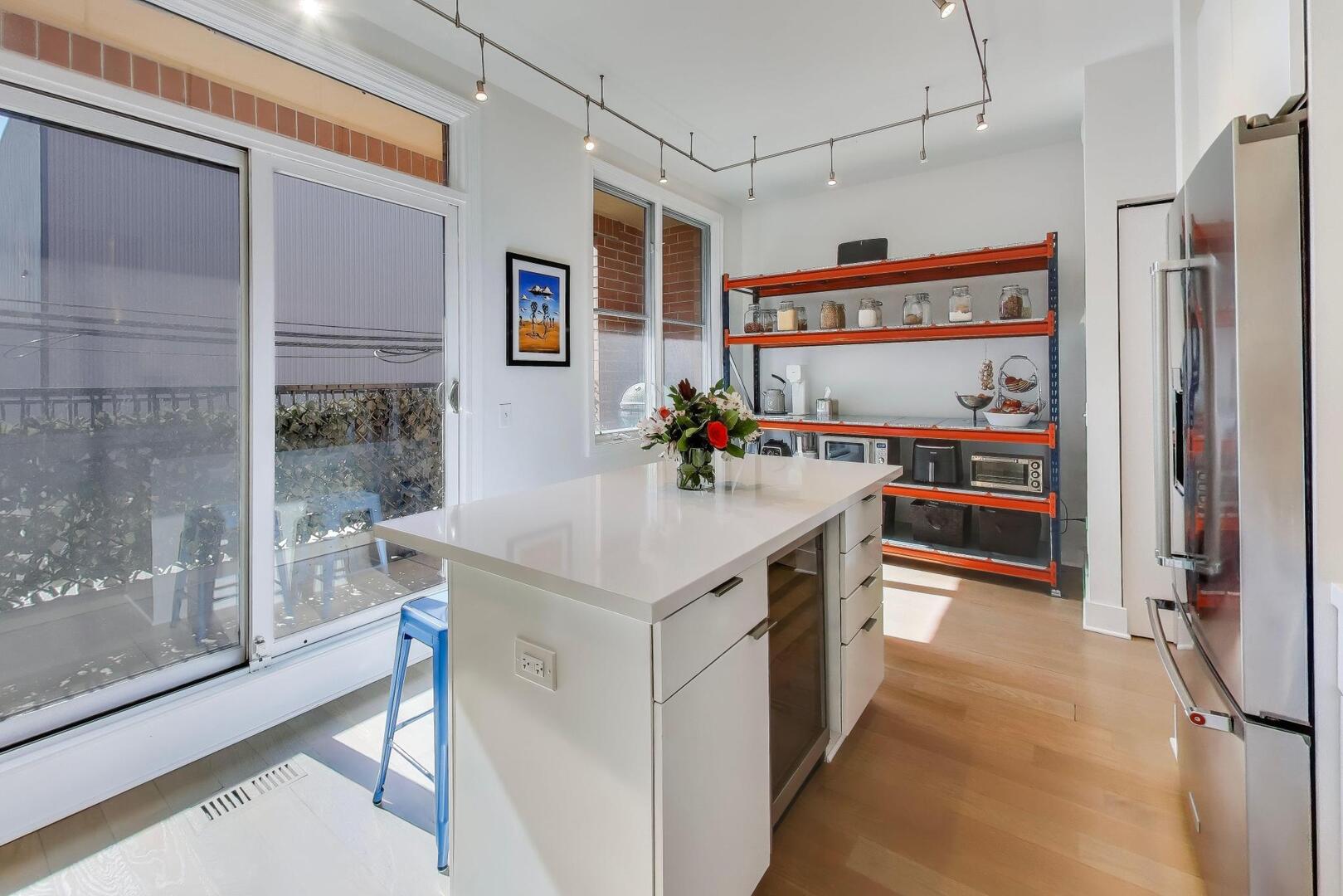 1137 West Monroe Street, Unit 9 Chicago, IL 60607 - Photo 7 of 31 a kitchen with stainless steel appliances a sink and a refrigerator