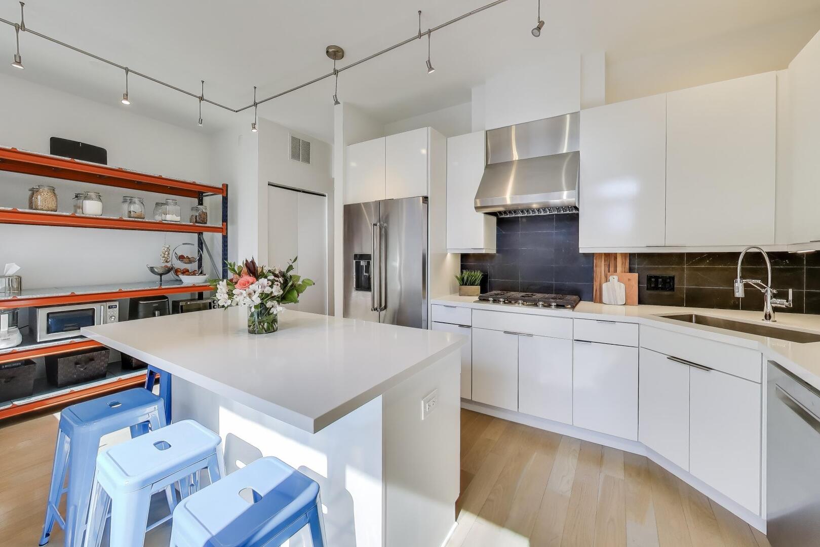 1137 West Monroe Street, Unit 9 Chicago, IL 60607 - Photo 8 of 31 a kitchen with stainless steel appliances granite countertop a sink dishwasher and a refrigerator