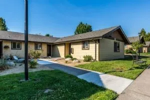 a view of a house with backyard and garden