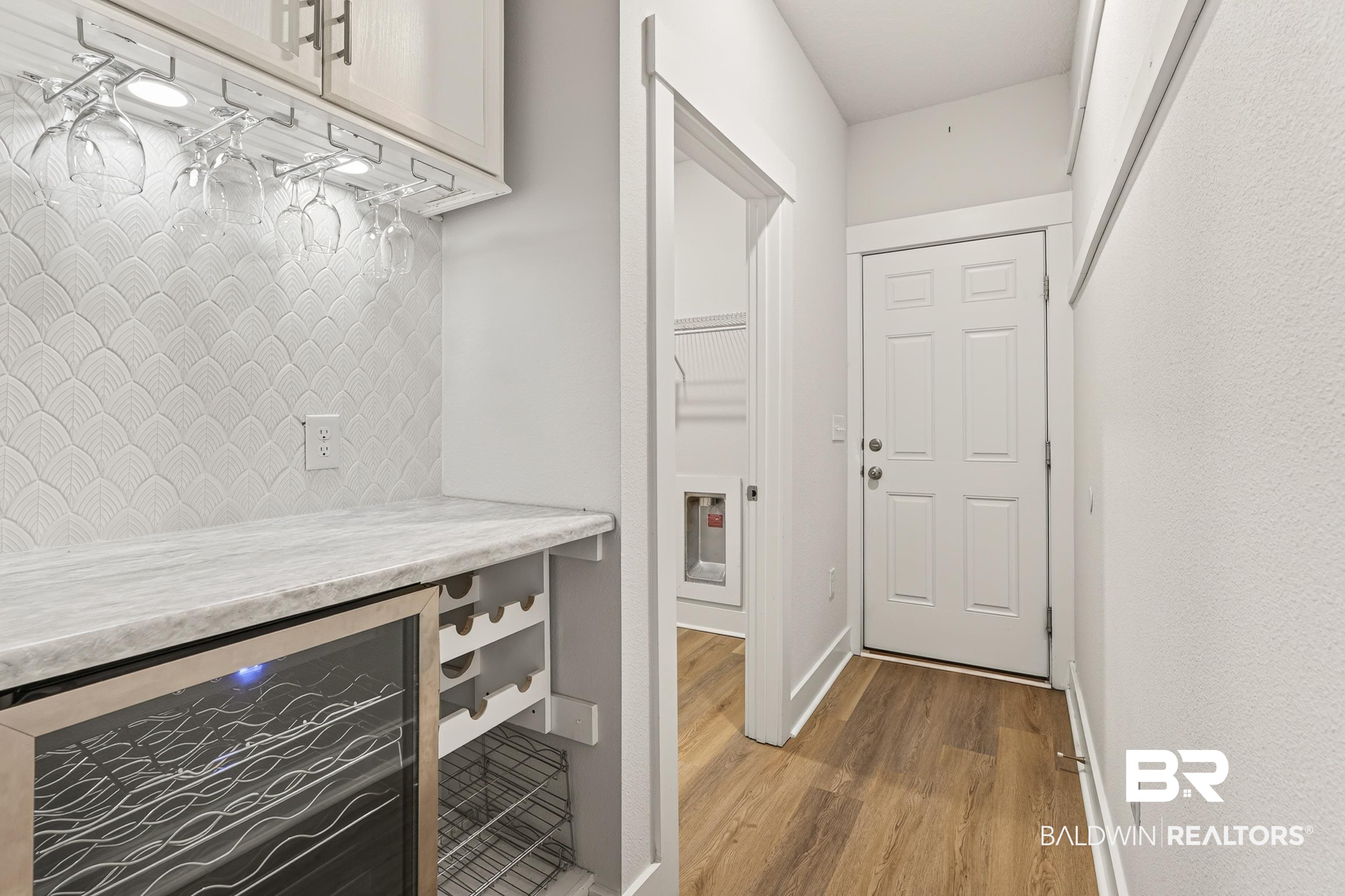 1724 Partridge Street Foley, AL 36535 - Photo 34 of 62 Beverage station featuring a marble-finish countertop, under-cabinet lighting, integrated wine rack, and beverage cooler