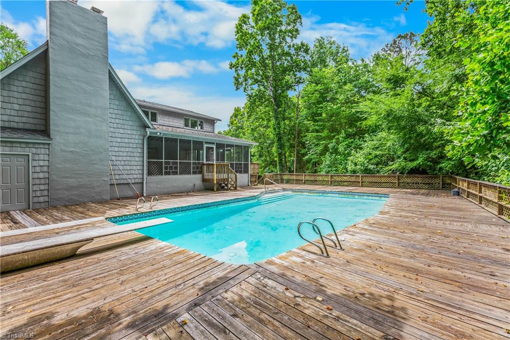 4200 Clinard Road Clemmons, NC 27012 - Photo 23 of 49 Pool with wooden decking and view of the screened in porch