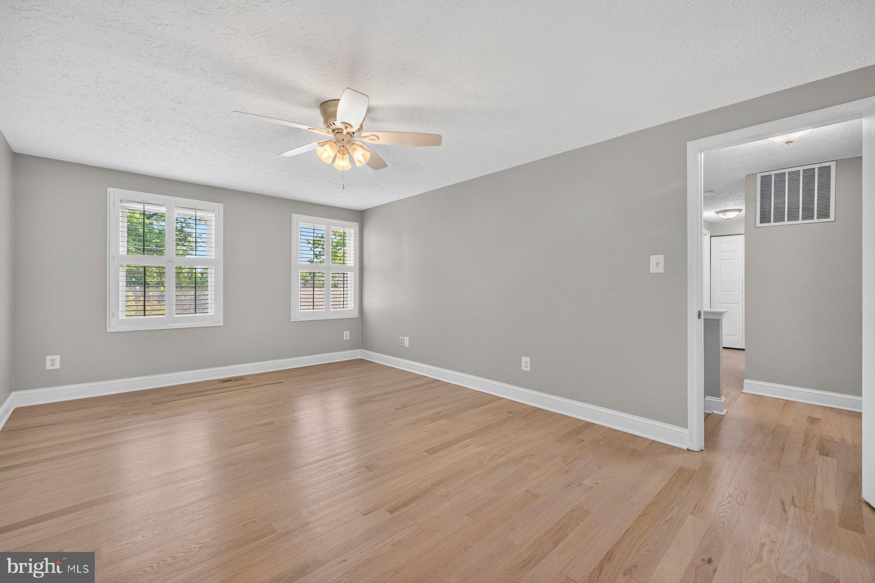 7518 Candytuft Court Springfield, VA 22153 - Photo 24 of 47 an empty room with wooden floor ceiling fan and windows