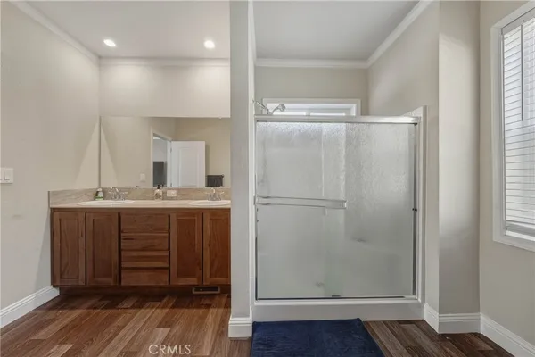 a bathroom with a shower a sink and a mirror