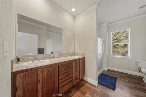 a spacious bathroom with a granite countertop sink and a mirror