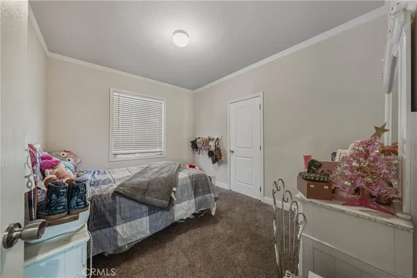 a bedroom with bed and a potted plant