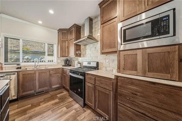 a kitchen with stainless steel appliances granite countertop a stove and a microwave
