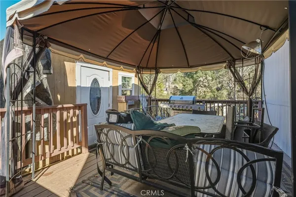a view of balcony with furniture and umbrella