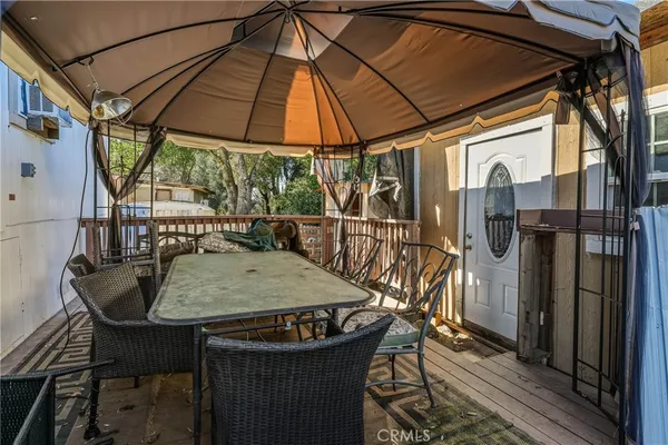 a view of balcony with wooden floor and outdoor seating