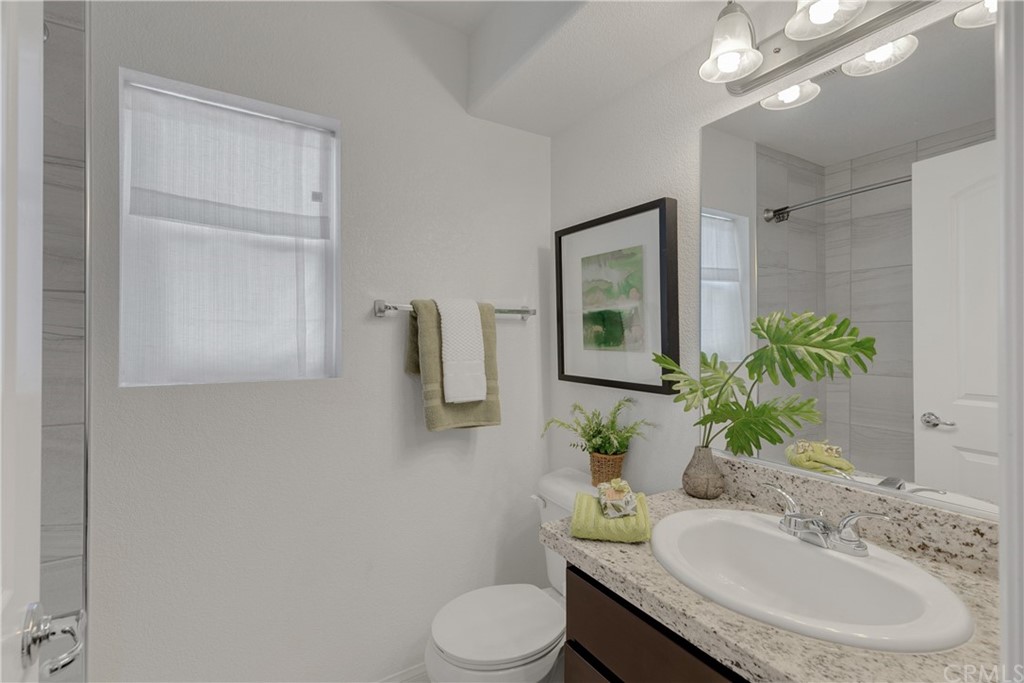 9016 Kimberly Ln. Cypress, CA 90630 - Photo 15 of 21 a bathroom with a sink vanity mirror and toilet