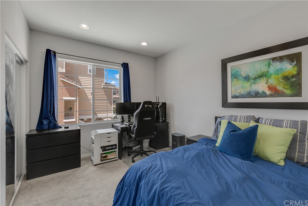 9016 Kimberly Ln. Cypress, CA 90630 - Photo 10 of 21 a bedroom with a large bed and a desk