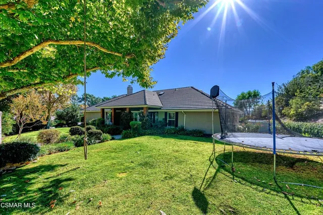 a view of a house with a yard potted plants