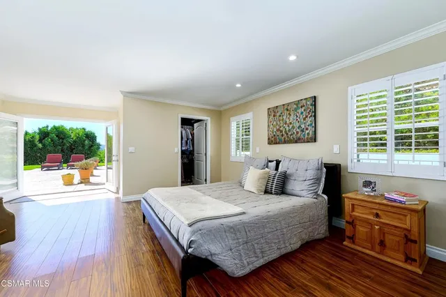 a view of a livingroom with wooden floor and a ceiling fan