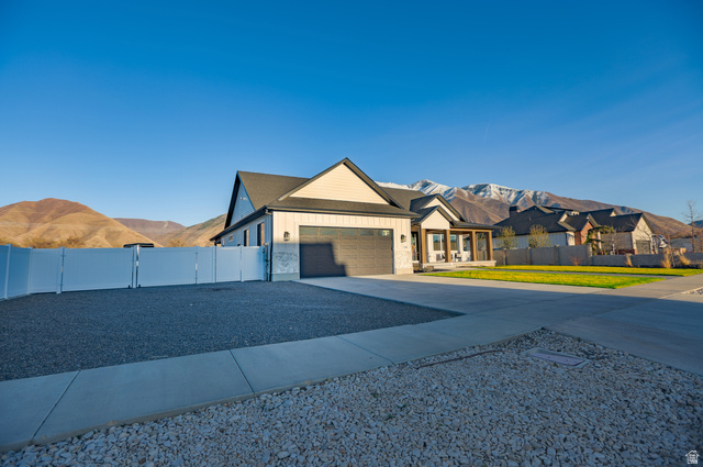 126 North 800 West Mapleton, UT 84664 - Photo 4 of 79 View of front facade featuring driveway, board and batten siding, a mountain view, a gate, and a garage