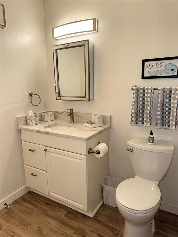 1550 South Belcher Road, Unit 335 Clearwater, FL 33764 - Photo 14 of 21 a bathroom with a toilet sink vanity and mirror