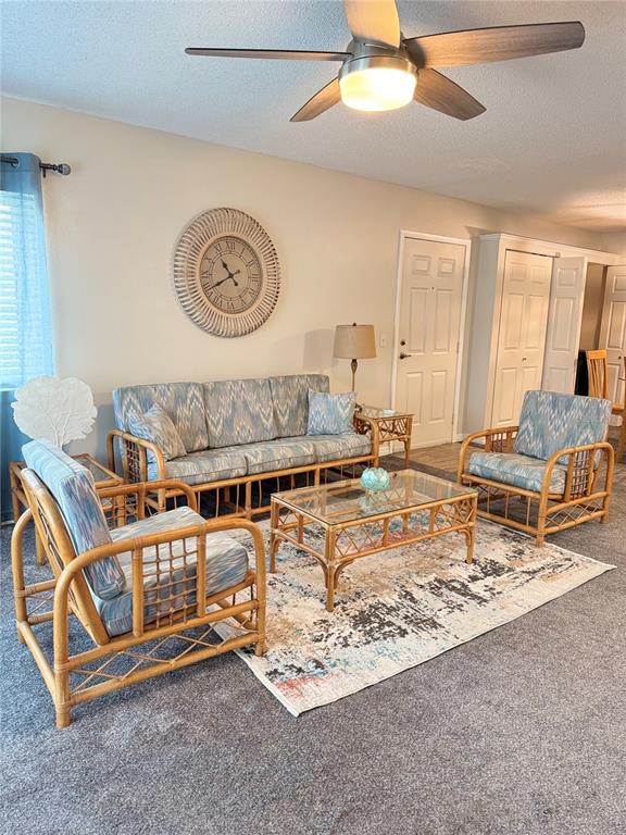 1550 South Belcher Road, Unit 335 Clearwater, FL 33764 - Photo 2 of 21 a living room with furniture a rug and a clock