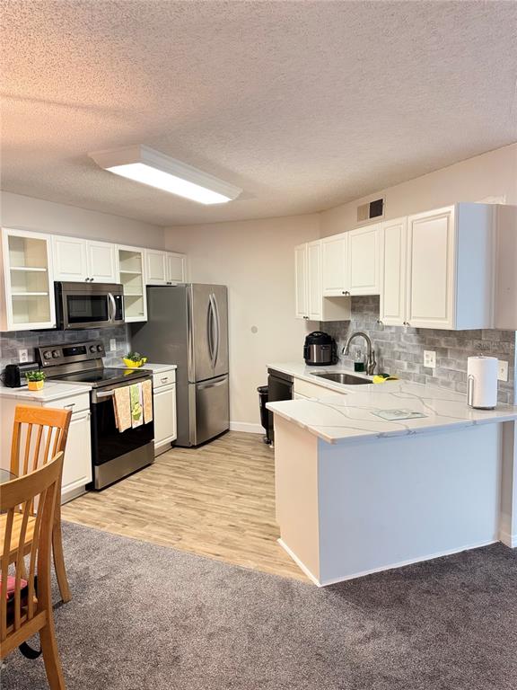 1550 South Belcher Road, Unit 335 Clearwater, FL 33764 - Photo 4 of 21 a kitchen with refrigerator and cabinets