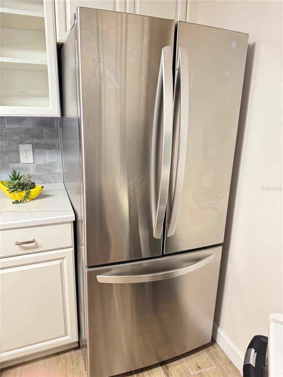 1550 South Belcher Road, Unit 335 Clearwater, FL 33764 - Photo 6 of 21 a view of a refrigerator with wooden floor
