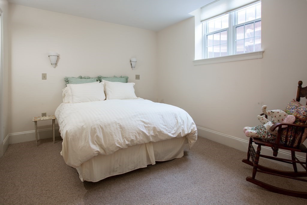 287 Langley Road, Unit 27 Newton, MA 02459 - Photo 13 of 17 a bedroom with a bed chair and window