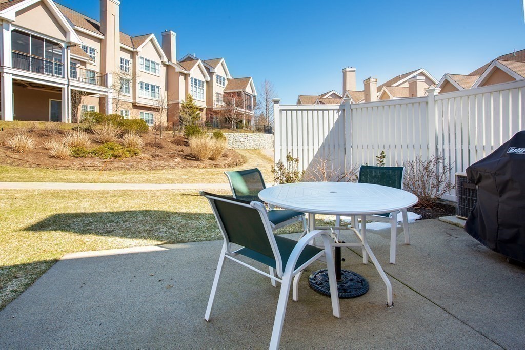 287 Langley Road, Unit 27 Newton, MA 02459 - Photo 14 of 17 a view of a chairs and table on the terrace
