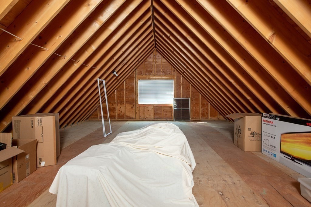 287 Langley Road, Unit 27 Newton, MA 02459 - Photo 15 of 17 a view of a bedroom with a bed and wooden floor