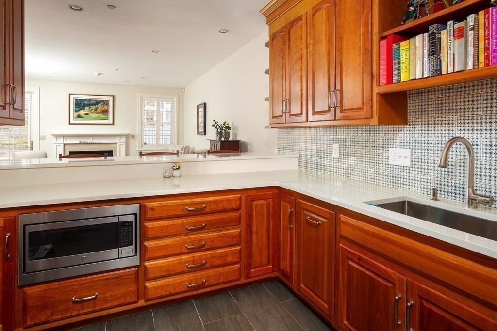 287 Langley Road, Unit 27 Newton, MA 02459 - Photo 6 of 17 a kitchen with stainless steel appliances granite countertop a sink and cabinets