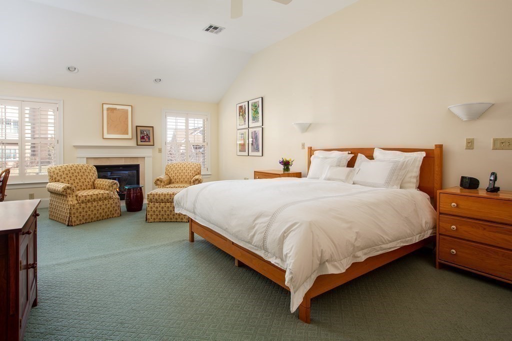 287 Langley Road, Unit 27 Newton, MA 02459 - Photo 7 of 17 a bed room with furniture and a fireplace