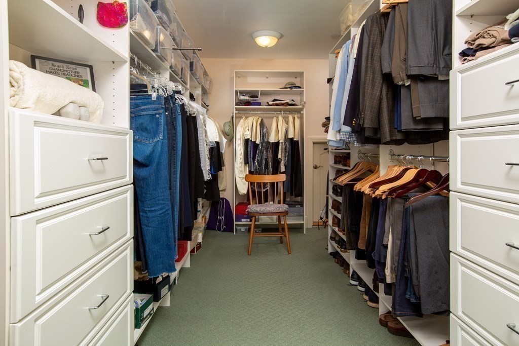 287 Langley Road, Unit 27 Newton, MA 02459 - Photo 9 of 17 a view of walk in closet with clothes and shoes