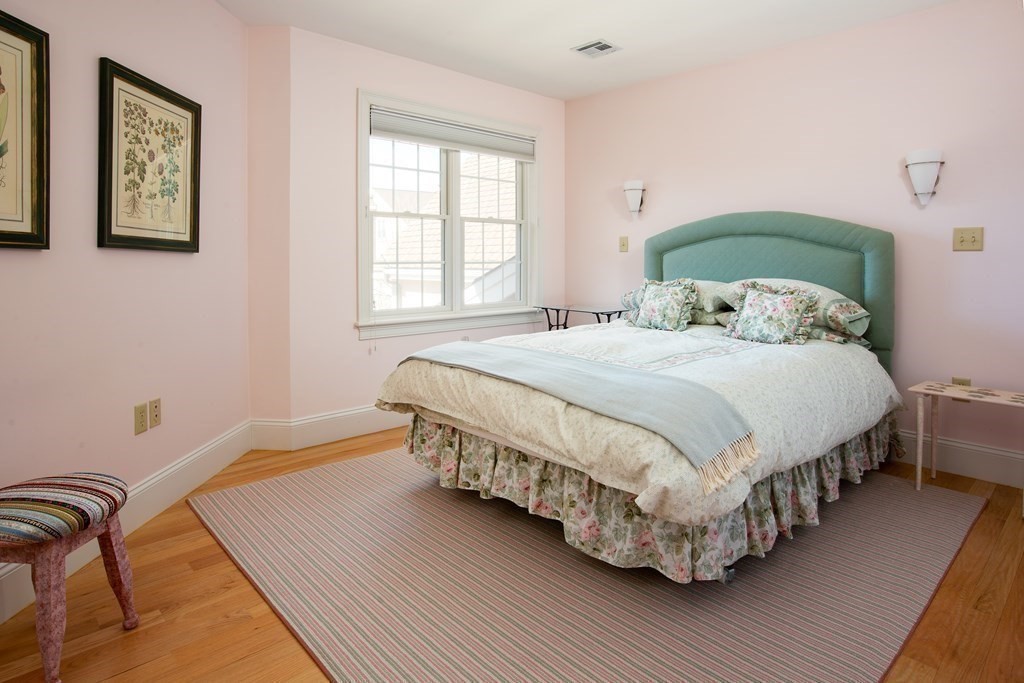 287 Langley Road, Unit 27 Newton, MA 02459 - Photo 10 of 17 a bedroom with a bed wooden floor and window