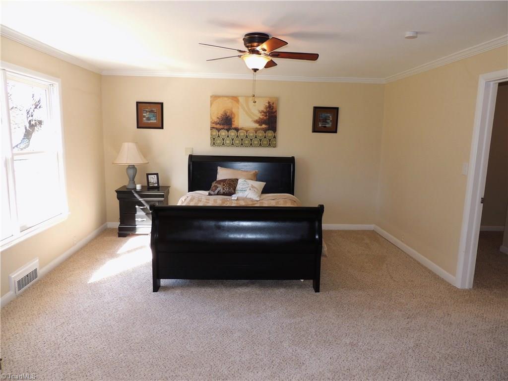 4017 Resthaven Road High Point, NC 27265 - Photo 14 of 29 The Master bedroom! Sunny and spacious with plush carpet, ceiling fan, and crown molding!