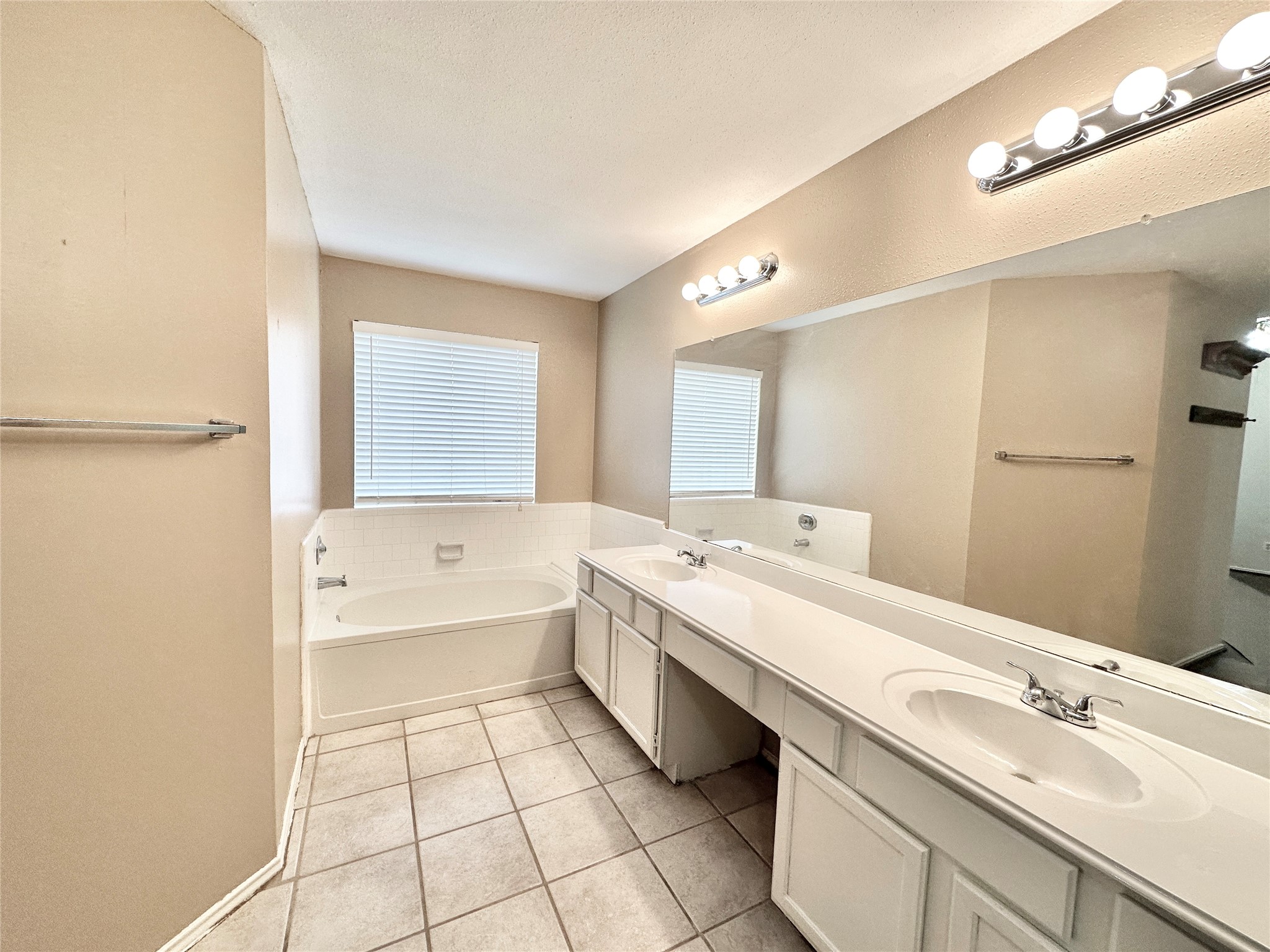 16827 Ashbridge Court Spring, TX 77379 - Photo 11 of 20 a bathroom with a double vanity sink mirror and bathtub