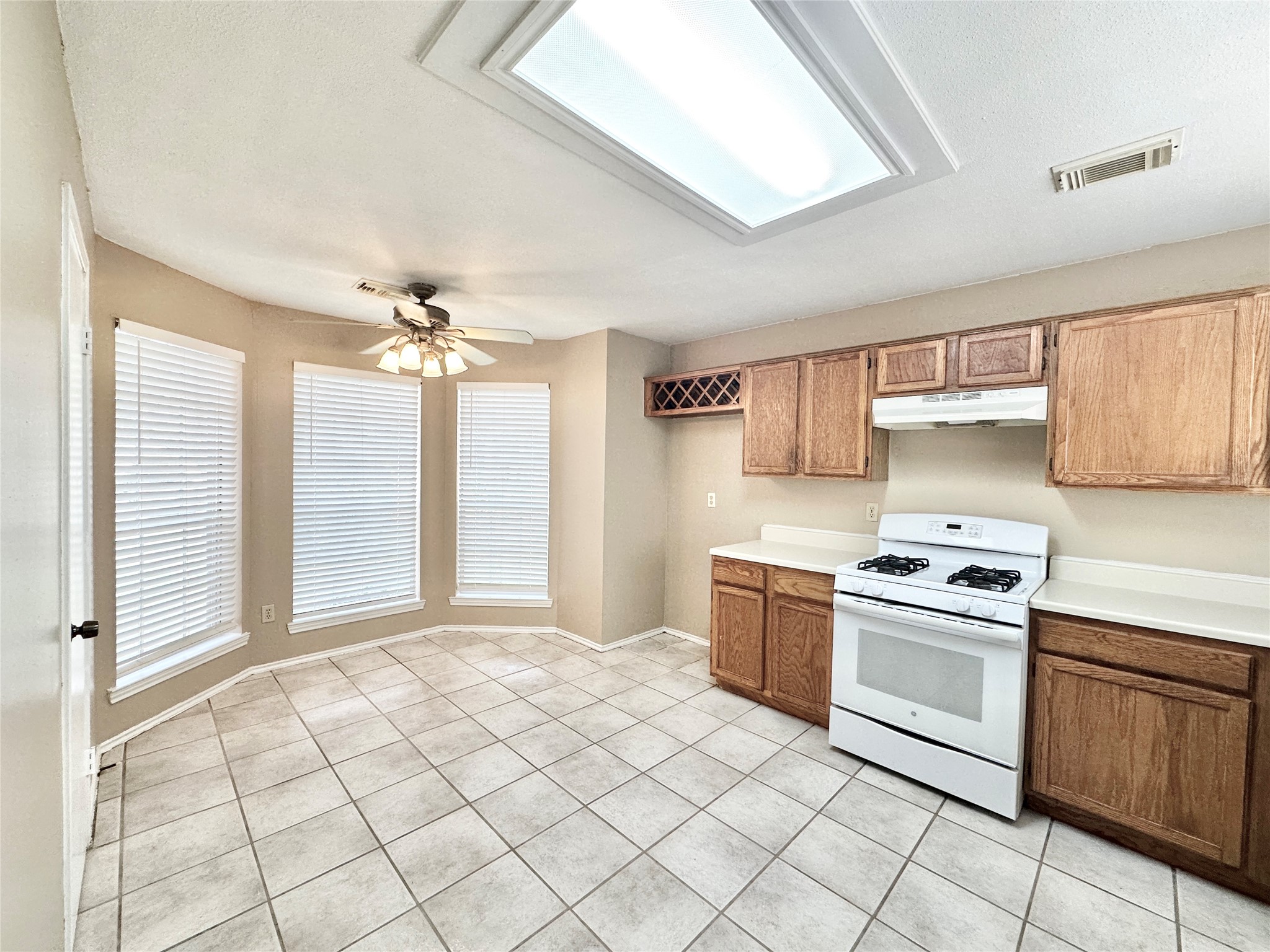 16827 Ashbridge Court Spring, TX 77379 - Photo 3 of 20 a kitchen with stainless steel appliances granite countertop a stove a sink and a refrigerator
