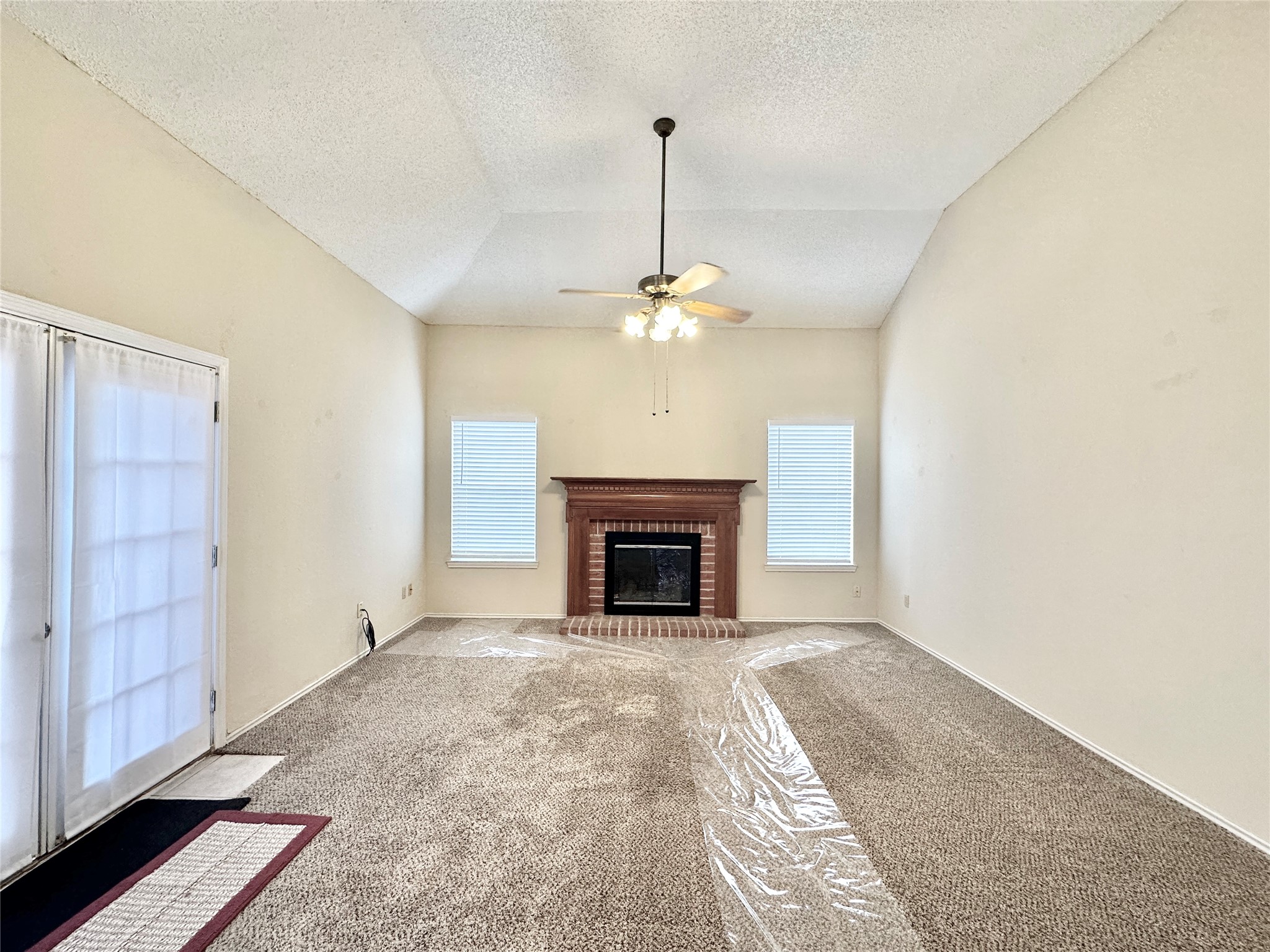 16827 Ashbridge Court Spring, TX 77379 - Photo 6 of 20 a view of a livingroom with an empty space and a fireplace