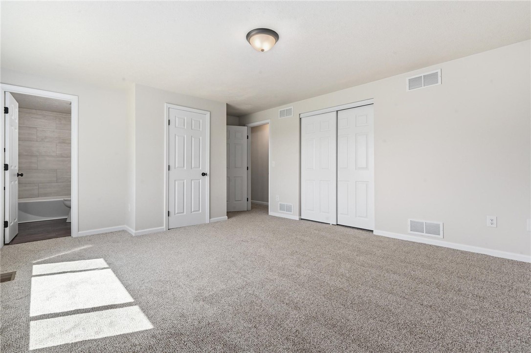 1353 Foust Road Xenia, OH 45385 - Photo 38 of 50 This spacious bedroom offers ample natural light, soft carpet, and convenient closet storage.