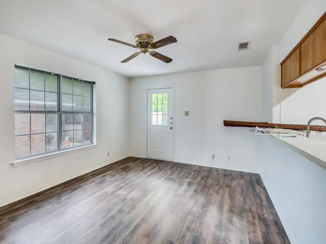 a view of a room with wooden floor and windows