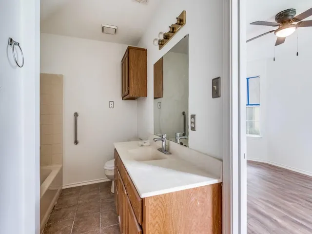 a bathroom with a sink vanity and mirror