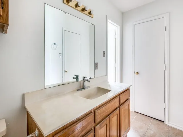 a bathroom with a sink vanity and a mirror