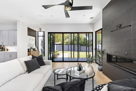 a living room with furniture and a floor to ceiling window