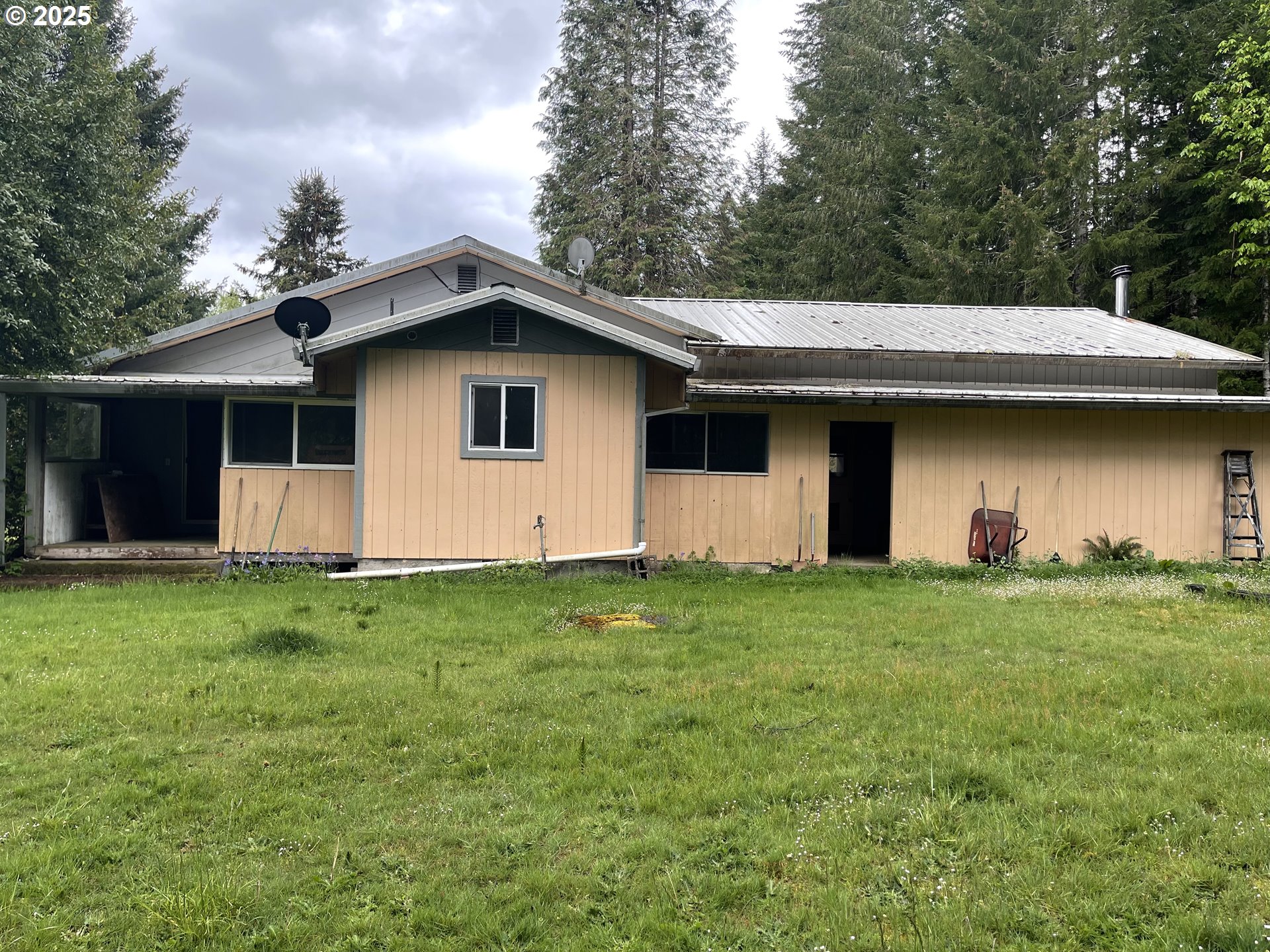 53610 Sourgrass Road Grand Ronde, OR 97347 - Photo 15 of 44 a house that is sitting in the grass