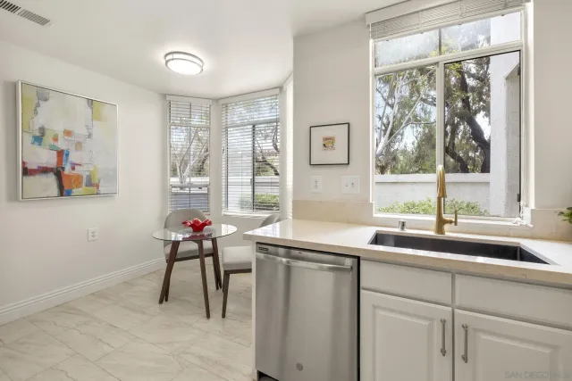 a kitchen with stainless steel appliances a refrigerator sink and microwave