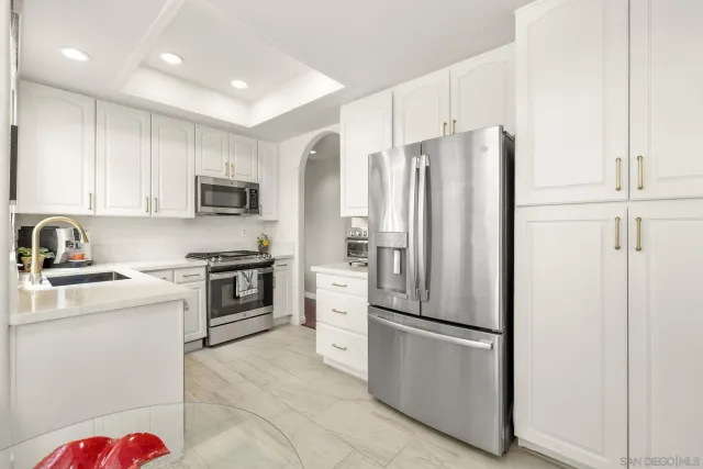 a kitchen with stainless steel appliances granite countertop a stove and a sink