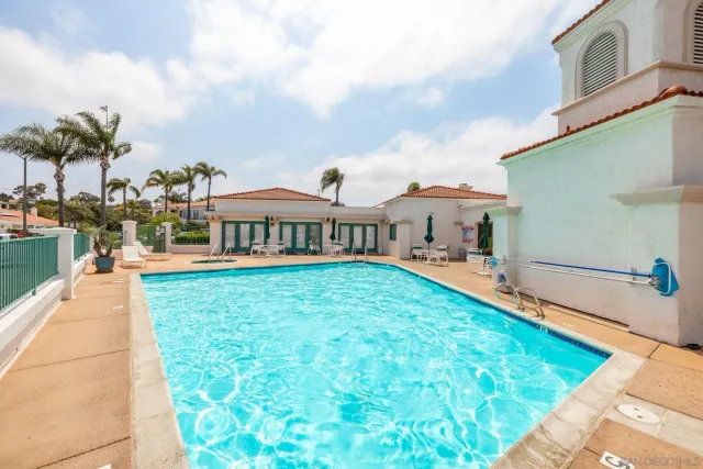 a swimming pool with outdoor seating and yard