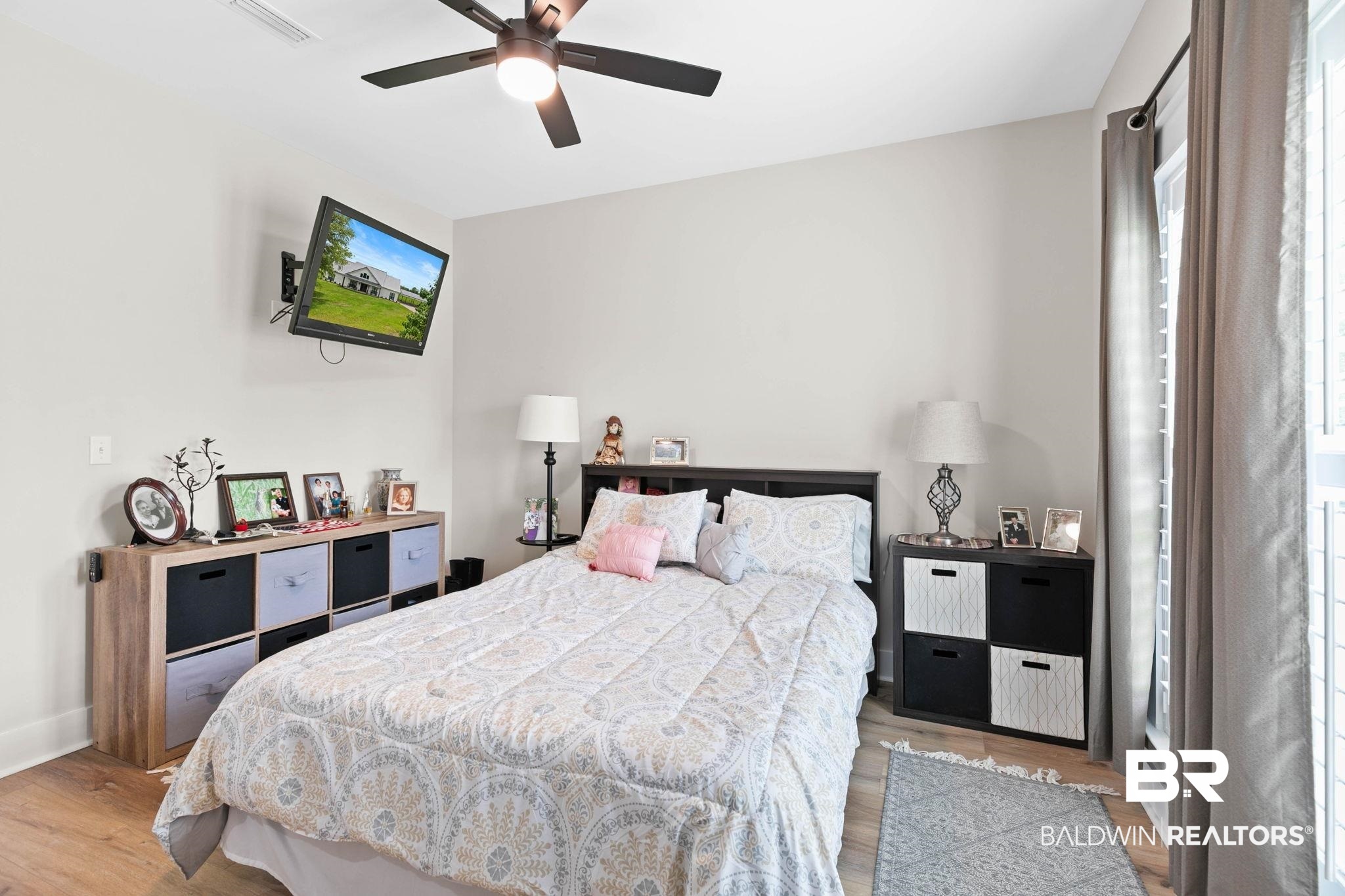 2029 George Lee Road Repton, AL 36475 - Photo 35 of 58 Room featuring wood-finish flooring, a ceiling fan with integrated lighting, and neutral wall paint