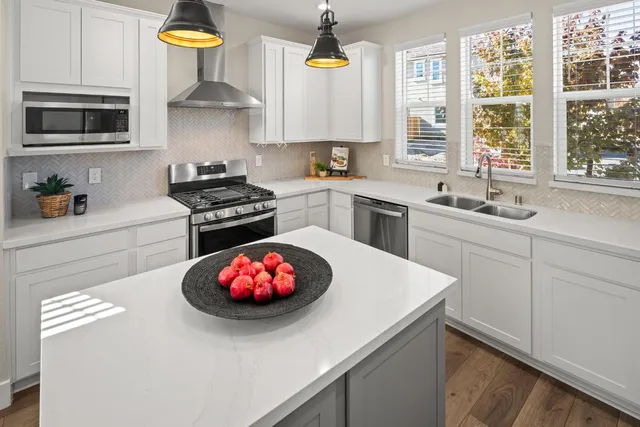 a kitchen with a sink a stove and cabinets