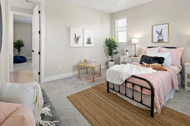 a bedroom with a bed and a table in it