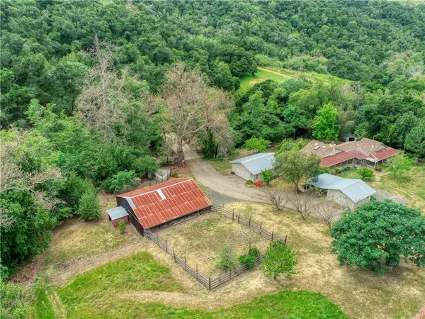 an aerial view of a house with a garden and swimming pool