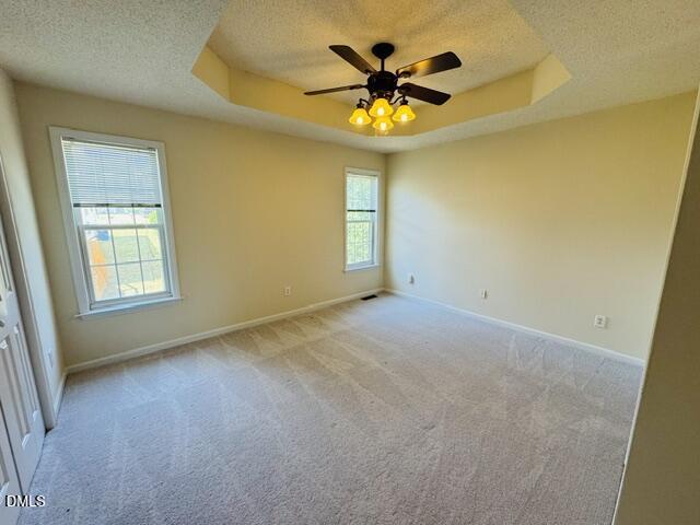2027 Turtle Point Drive Raleigh, NC 27604 - Photo 15 of 18 an empty room with a chandelier fan and a window