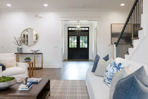 a kitchen with stainless steel appliances granite countertop a kitchen island a stove a cabinets a sink a chair and white cabinets